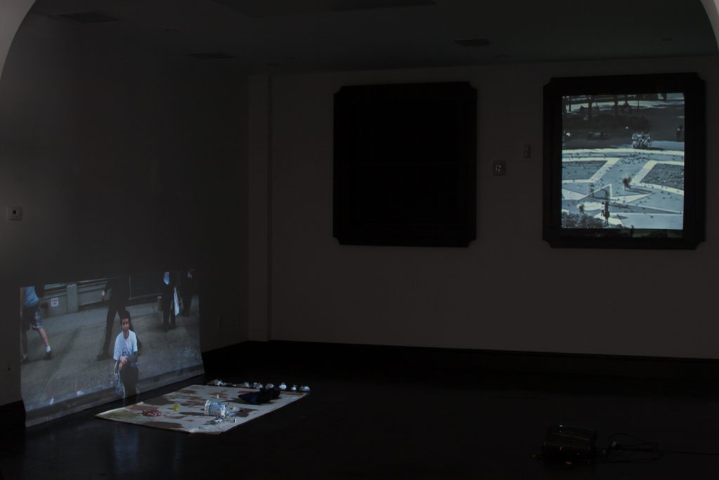 Installation view of a gallery with video projections