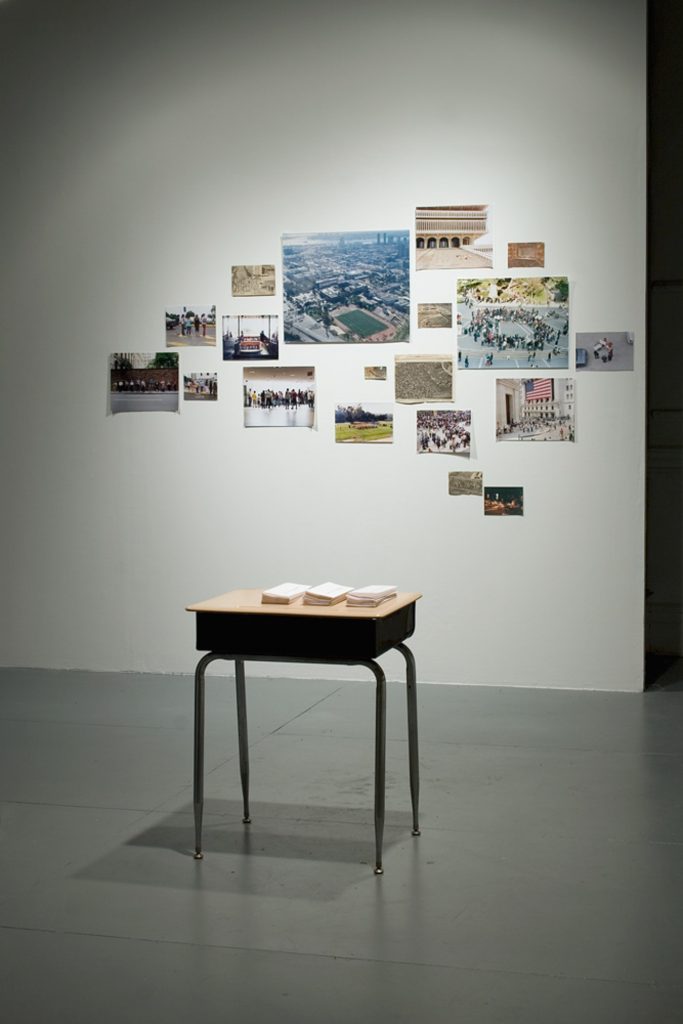 Desk with brochures with photographs in background 